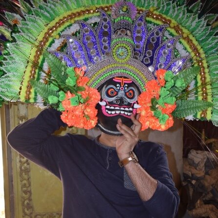 A man wearing a Chhau mask of Purulia, West Bengal